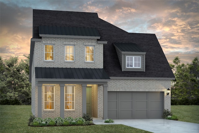 view of front of home with a lawn and a garage