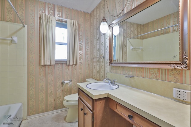 full bathroom featuring washtub / shower combination, vanity, and toilet