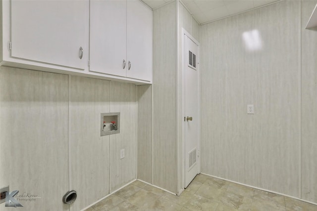 washroom with cabinets and washer hookup