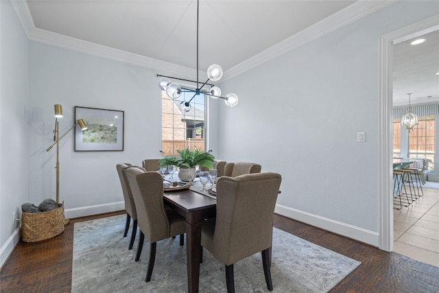 dining area with ornamental molding, dark hardwood / wood-style floors, and an inviting chandelier