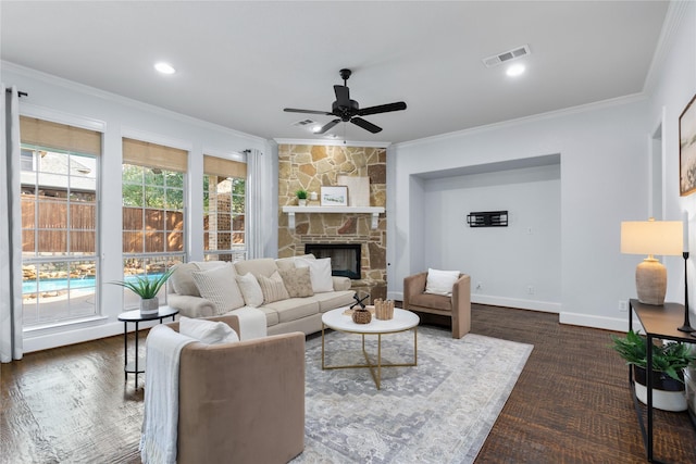 living room featuring crown molding, a fireplace, and ceiling fan