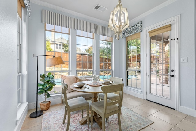 sunroom / solarium with a notable chandelier