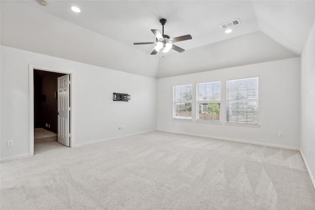 carpeted spare room featuring lofted ceiling and ceiling fan