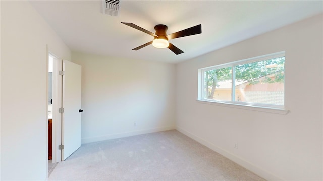 unfurnished room featuring ceiling fan and light carpet