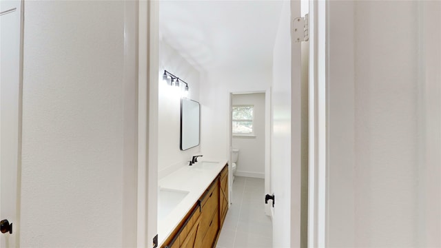 bathroom with tile patterned floors, vanity, and toilet