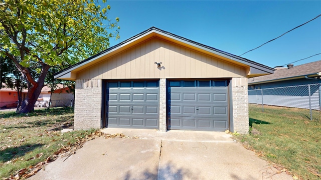 garage featuring a lawn