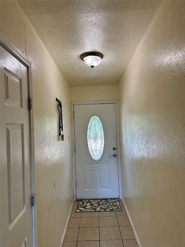 entryway featuring a textured ceiling and light tile patterned floors