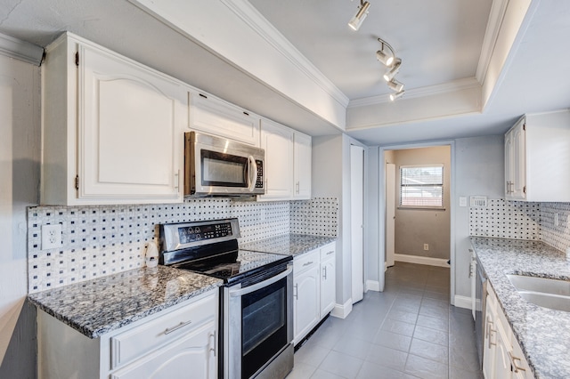 kitchen featuring white cabinets, stainless steel appliances, and rail lighting