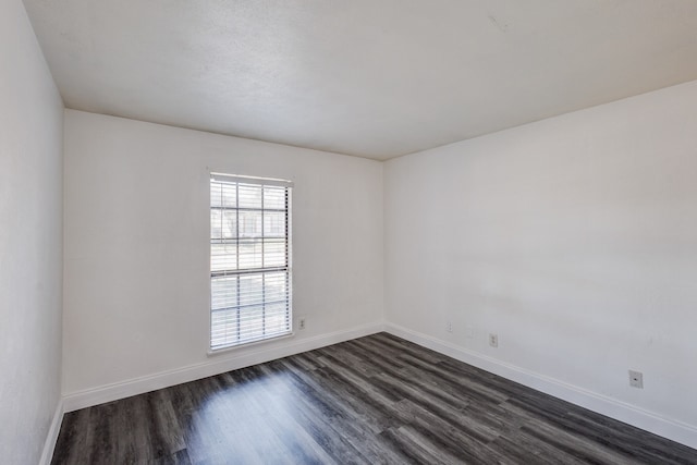 unfurnished room with dark hardwood / wood-style floors