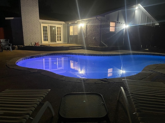 view of pool at night