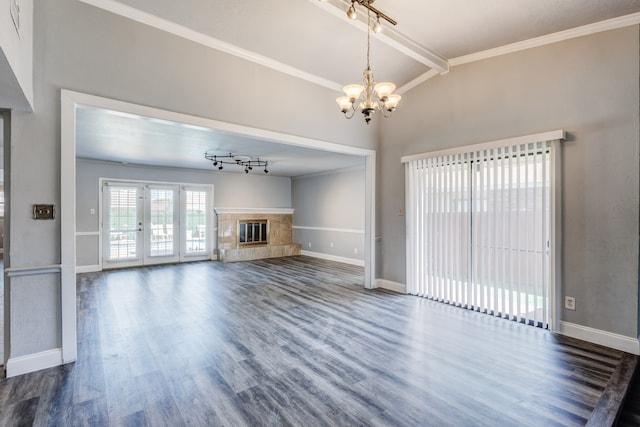 unfurnished living room with crown molding, dark wood-type flooring, a tile fireplace, a chandelier, and vaulted ceiling with beams