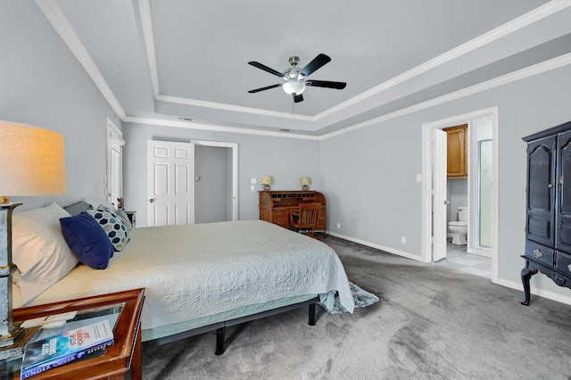 bedroom with connected bathroom, a raised ceiling, ceiling fan, and ornamental molding