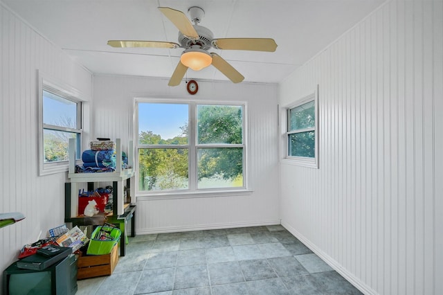 unfurnished sunroom with ceiling fan and a healthy amount of sunlight