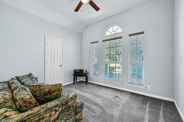 sitting room with ceiling fan, lofted ceiling, and carpet floors