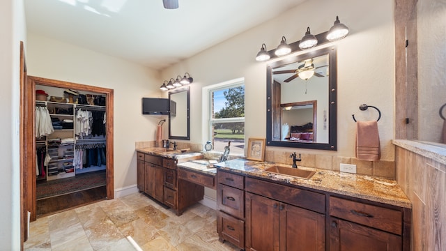 bathroom with ceiling fan and vanity