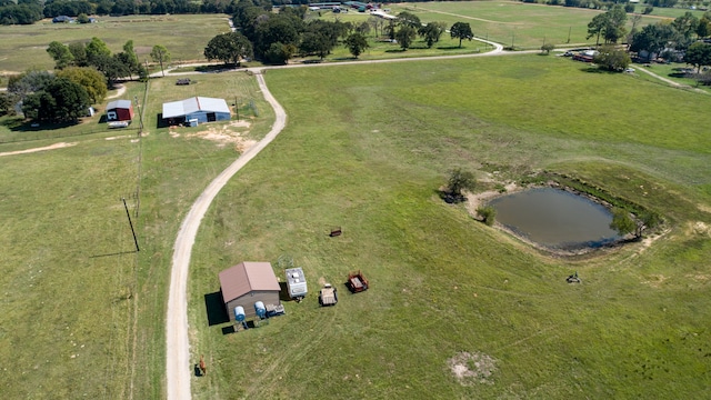 birds eye view of property featuring a water view and a rural view