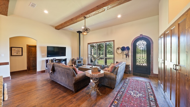 living room featuring beam ceiling and dark hardwood / wood-style flooring