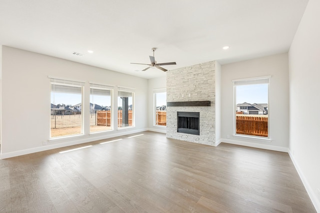 unfurnished living room featuring hardwood / wood-style floors, a fireplace, and ceiling fan