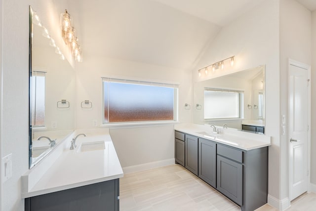 bathroom featuring vaulted ceiling and vanity