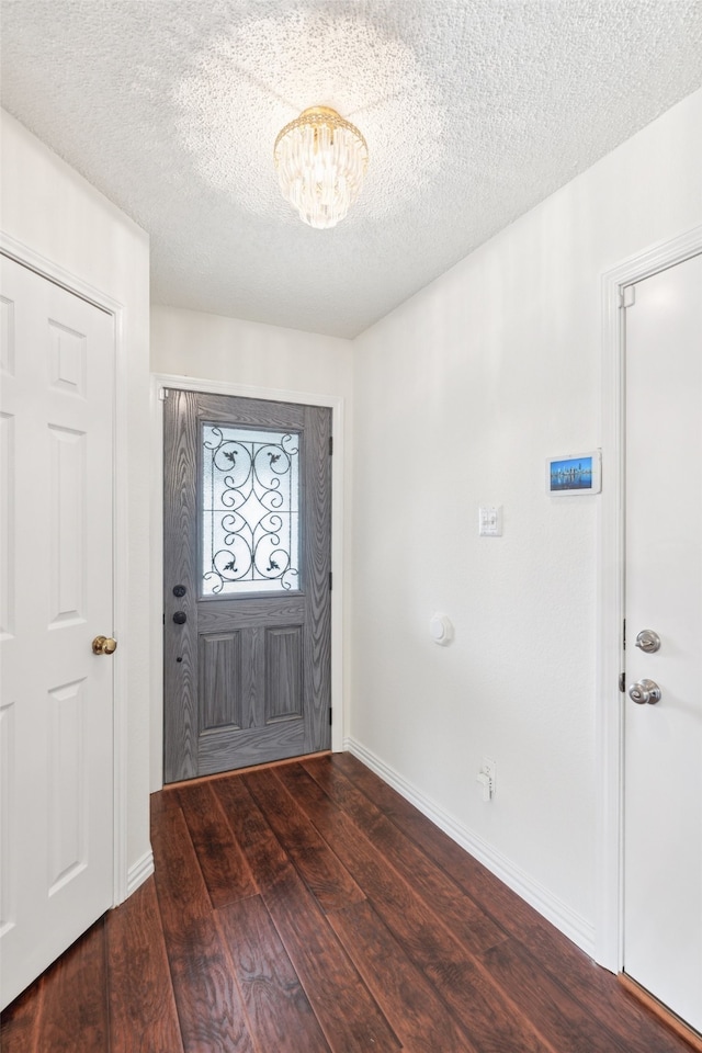 foyer featuring a textured ceiling and dark hardwood / wood-style flooring