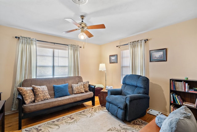 living room featuring hardwood / wood-style floors and ceiling fan