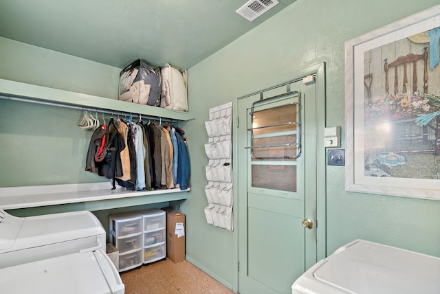 clothes washing area featuring separate washer and dryer