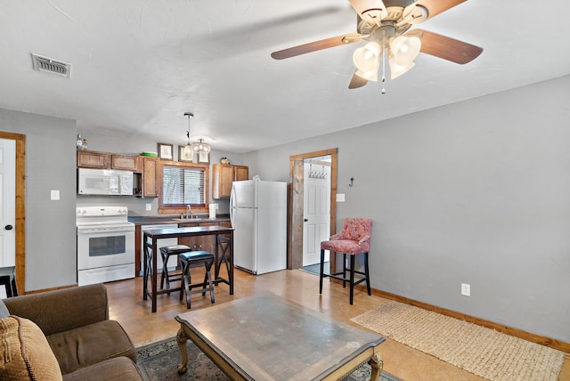 living room featuring ceiling fan and sink