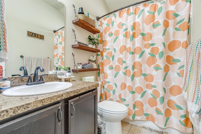 bathroom with a shower with curtain, tile patterned floors, vanity, and toilet