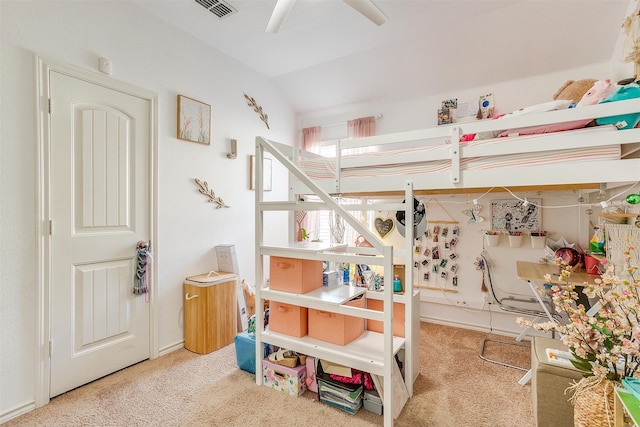 carpeted bedroom with ceiling fan and vaulted ceiling