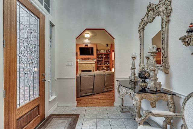 foyer featuring light hardwood / wood-style flooring and a fireplace