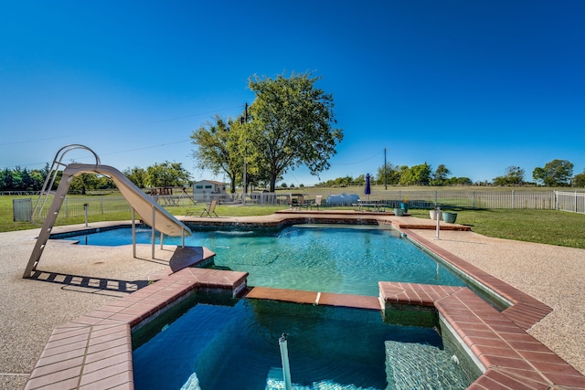 view of pool featuring a lawn, an in ground hot tub, and a water slide