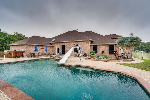 view of pool with a patio and a water slide