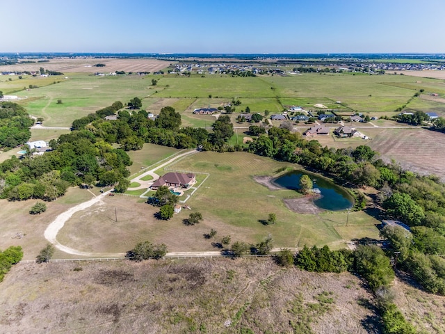 birds eye view of property with a water view and a rural view