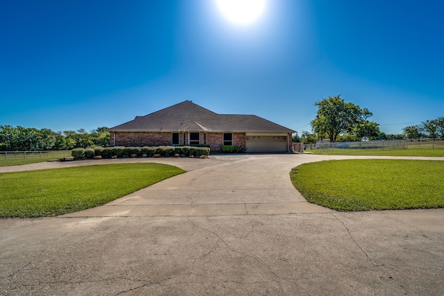 ranch-style house with a garage and a front yard