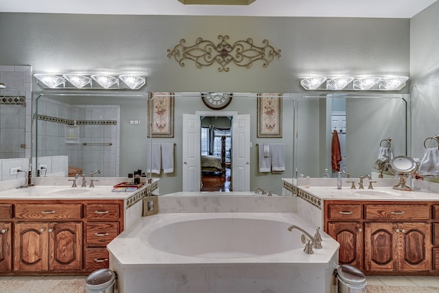 bathroom featuring shower with separate bathtub, tile patterned floors, and vanity