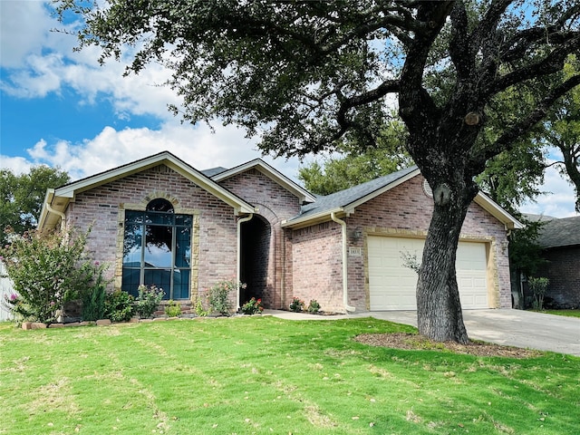 view of front of house with a garage and a front lawn