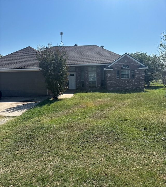 single story home featuring a garage and a front yard