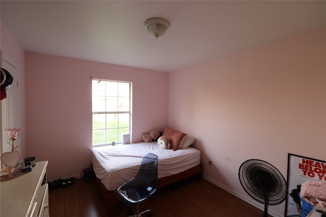 bedroom with dark hardwood / wood-style floors