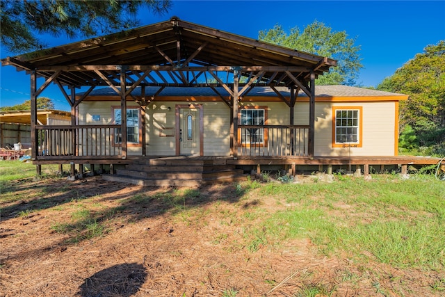 rear view of property featuring a deck