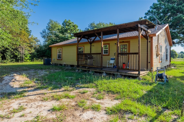 back of property featuring central AC unit and a deck