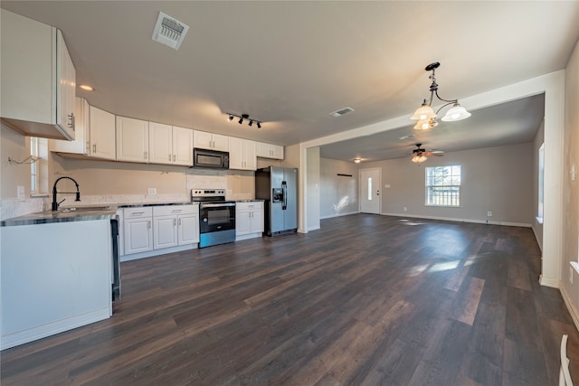 kitchen featuring appliances with stainless steel finishes, sink, dark hardwood / wood-style floors, and white cabinets