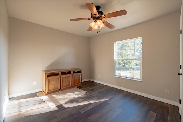 empty room featuring ceiling fan and dark wood-type flooring