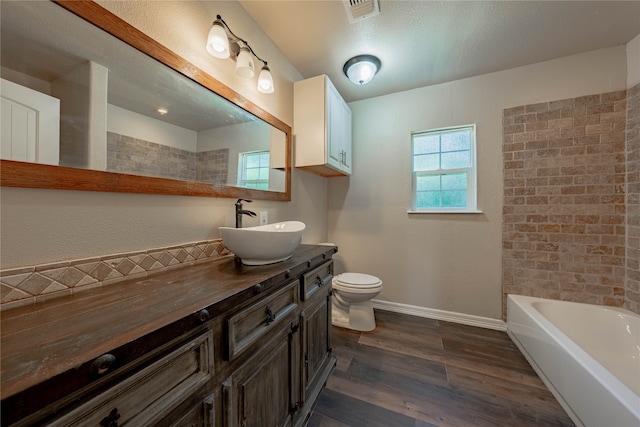 bathroom featuring wood-type flooring, vanity, and toilet