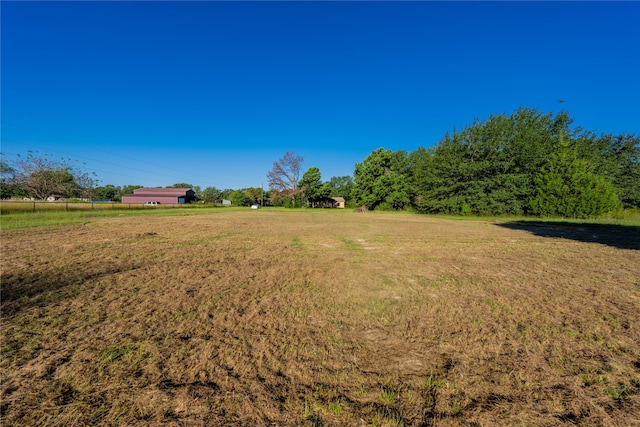 view of yard with a rural view