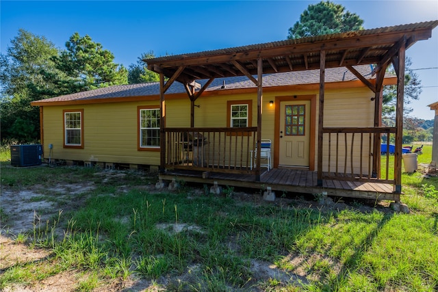 back of house with central air condition unit and a wooden deck