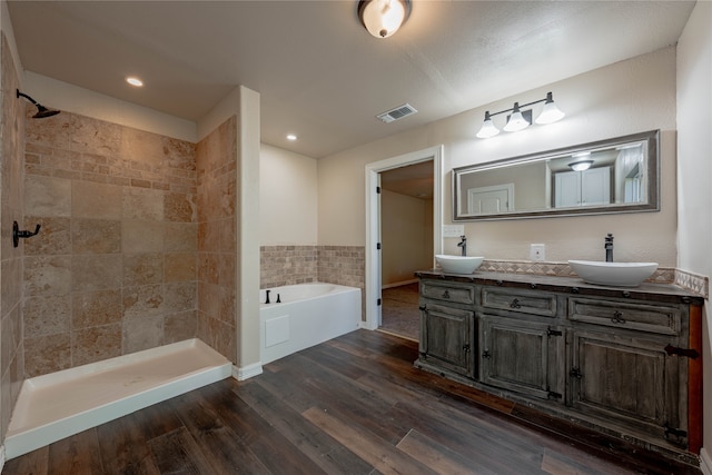 bathroom featuring wood-type flooring, vanity, and independent shower and bath