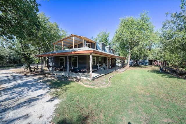 exterior space with a front yard, a wooden deck, and a patio area