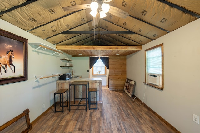 interior space with wood ceiling, vaulted ceiling, dark hardwood / wood-style flooring, ceiling fan, and sink