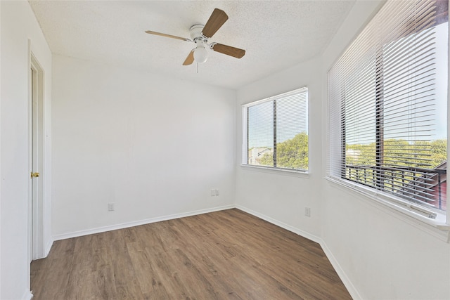 empty room featuring a textured ceiling, hardwood / wood-style flooring, and ceiling fan