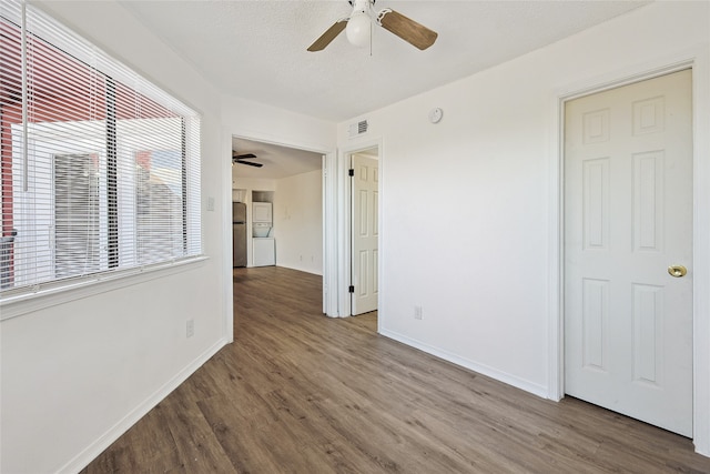 unfurnished room with wood-type flooring, ceiling fan, and a textured ceiling